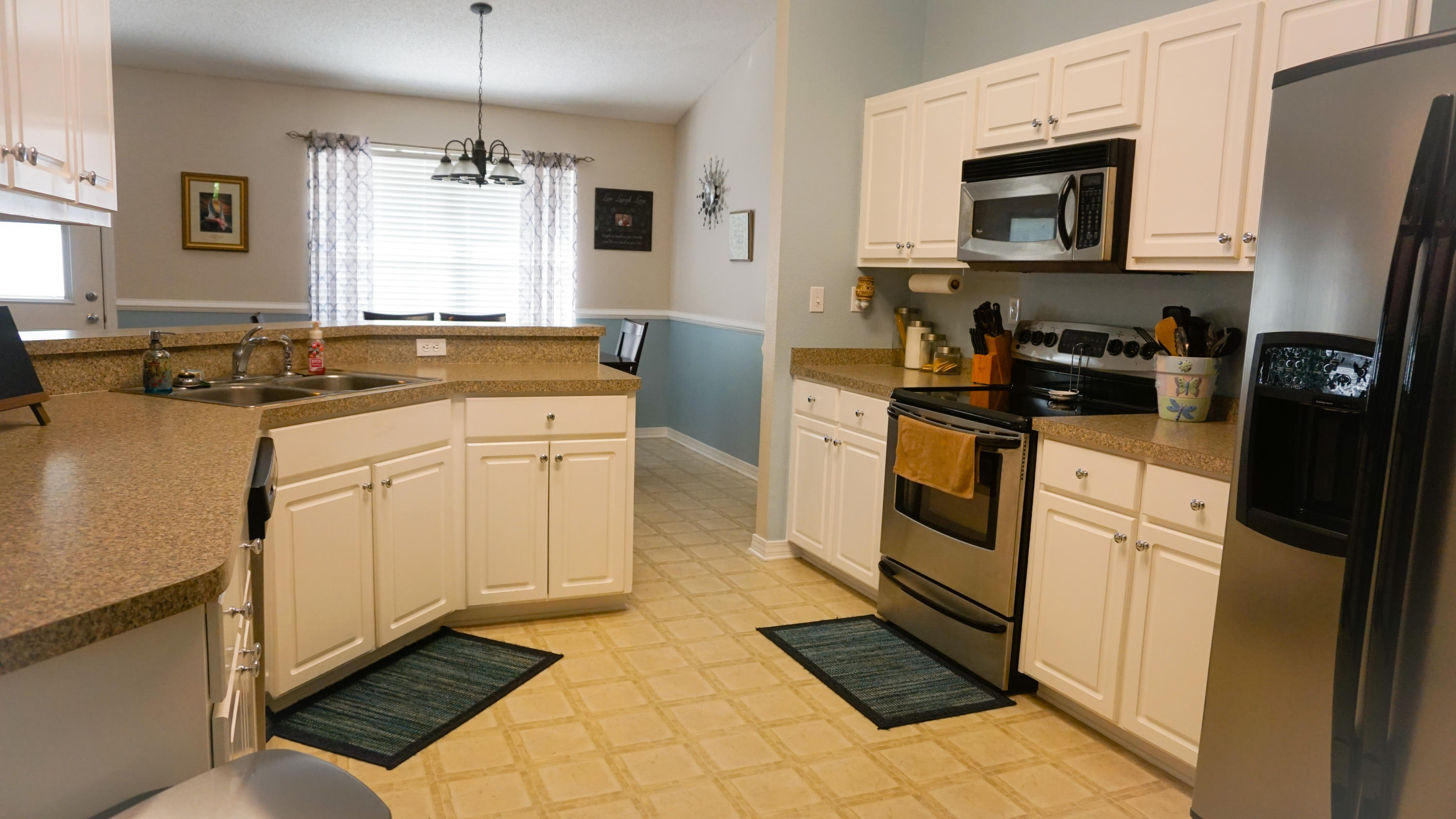 2126 Hagood Loop Crestview, FL 32536 - Photo 4 of 18 a kitchen with a sink stove and refrigerator
