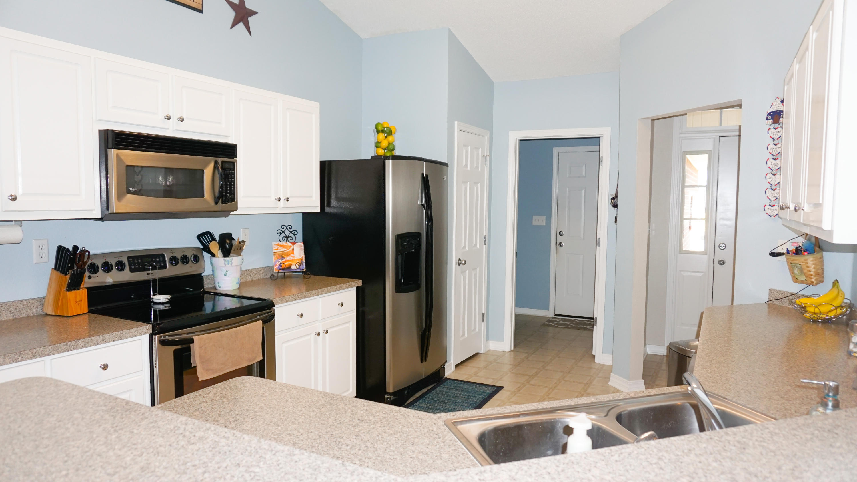 2126 Hagood Loop Crestview, FL 32536 - Photo 5 of 18 a kitchen with a refrigerator a stove a sink and a cabinets