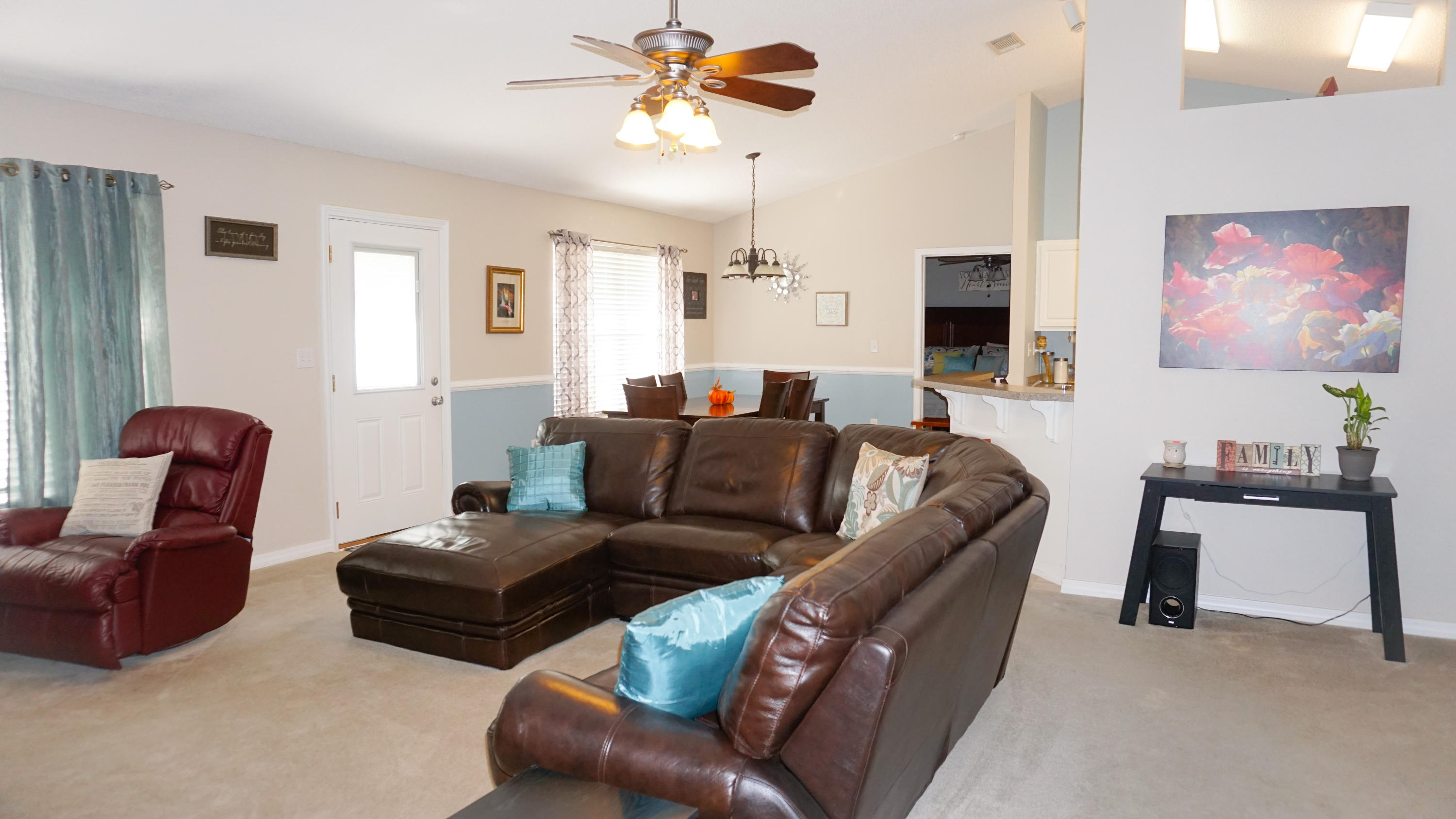 2126 Hagood Loop Crestview, FL 32536 - Photo 7 of 18 a living room with furniture a ceiling fan and a window