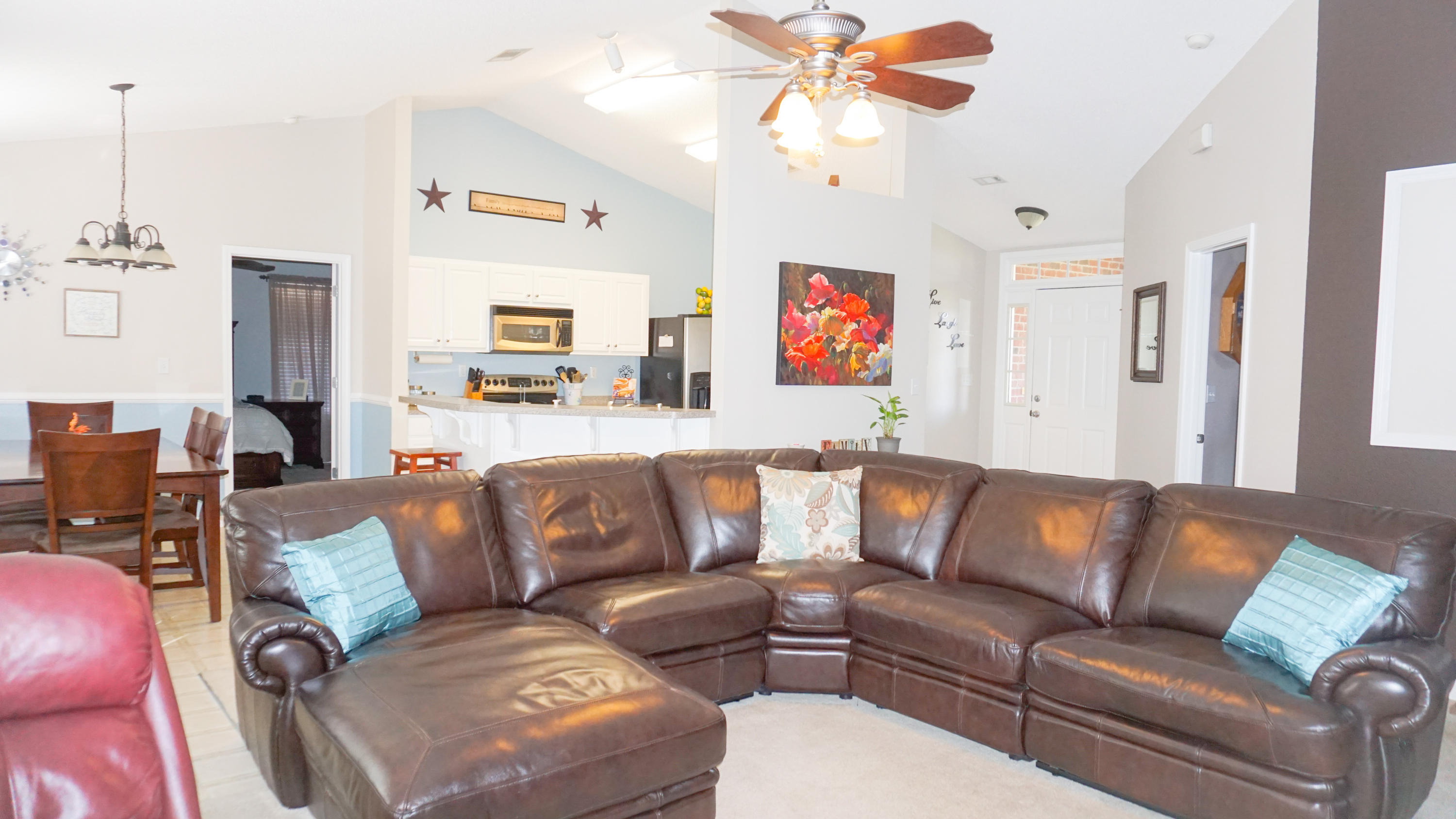 2126 Hagood Loop Crestview, FL 32536 - Photo 8 of 18 a living room with furniture kitchen view and a chandelier