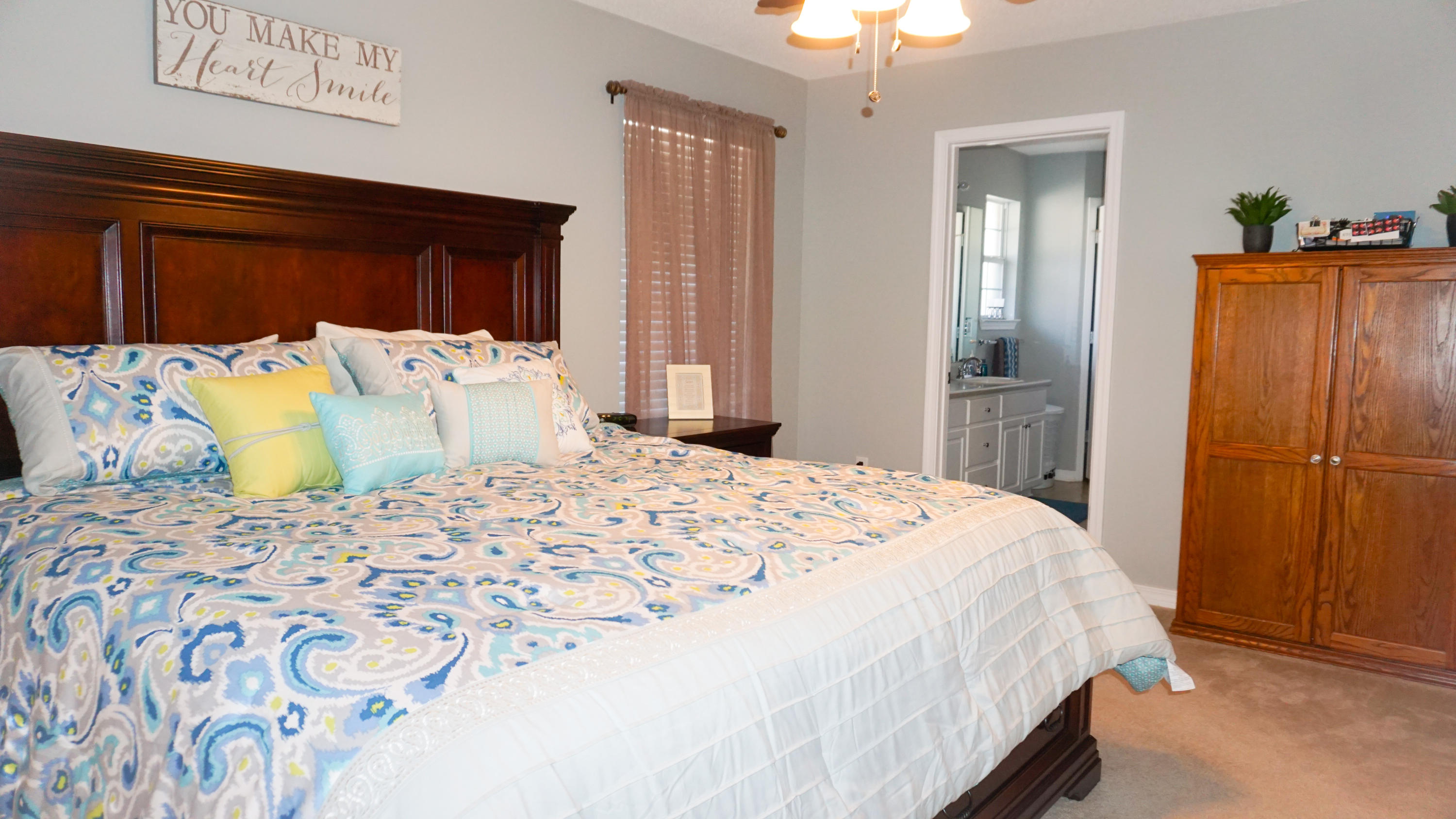 2126 Hagood Loop Crestview, FL 32536 - Photo 9 of 18 a bedroom with a large bed and a chandelier