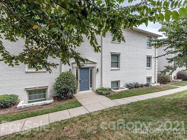 4913 Park Road, Unit D Charlotte, NC 28209 - Photo 1 of 32 a front view of a house with a yard and garage