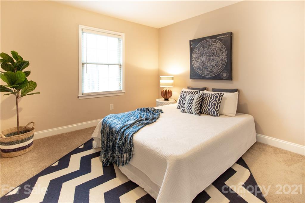 4913 Park Road, Unit D Charlotte, NC 28209 - Photo 12 of 32 a bedroom with a bed and a window
