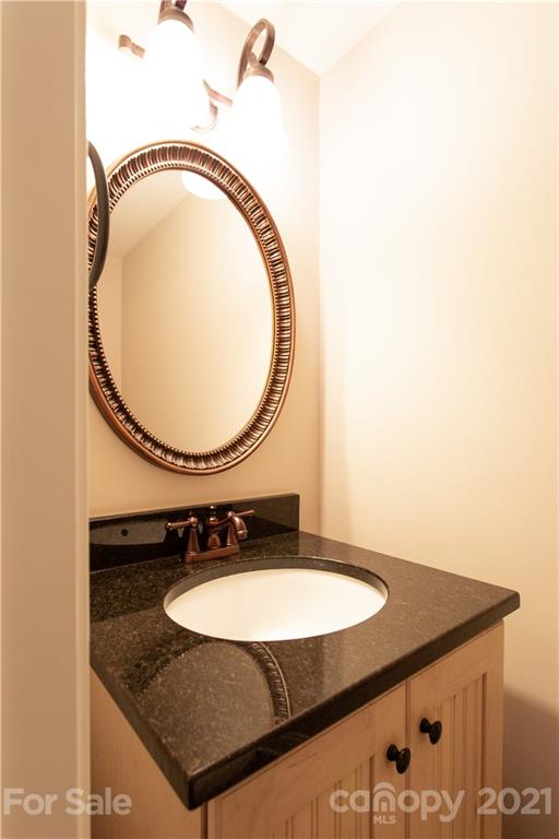 4913 Park Road, Unit D Charlotte, NC 28209 - Photo 14 of 32 a bathroom with a sink and a mirror