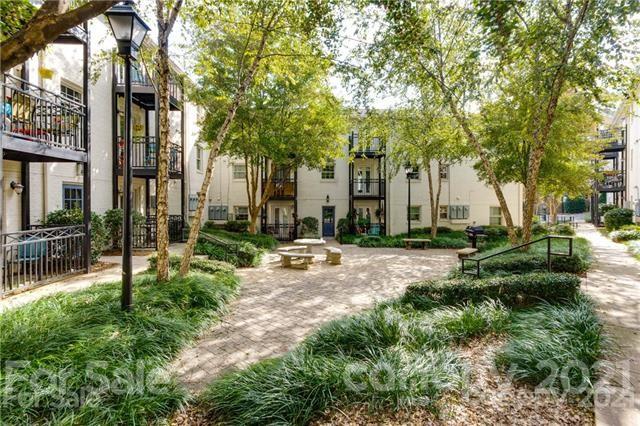 4913 Park Road, Unit D Charlotte, NC 28209 - Photo 18 of 32 a view of a building with a yard and sitting area