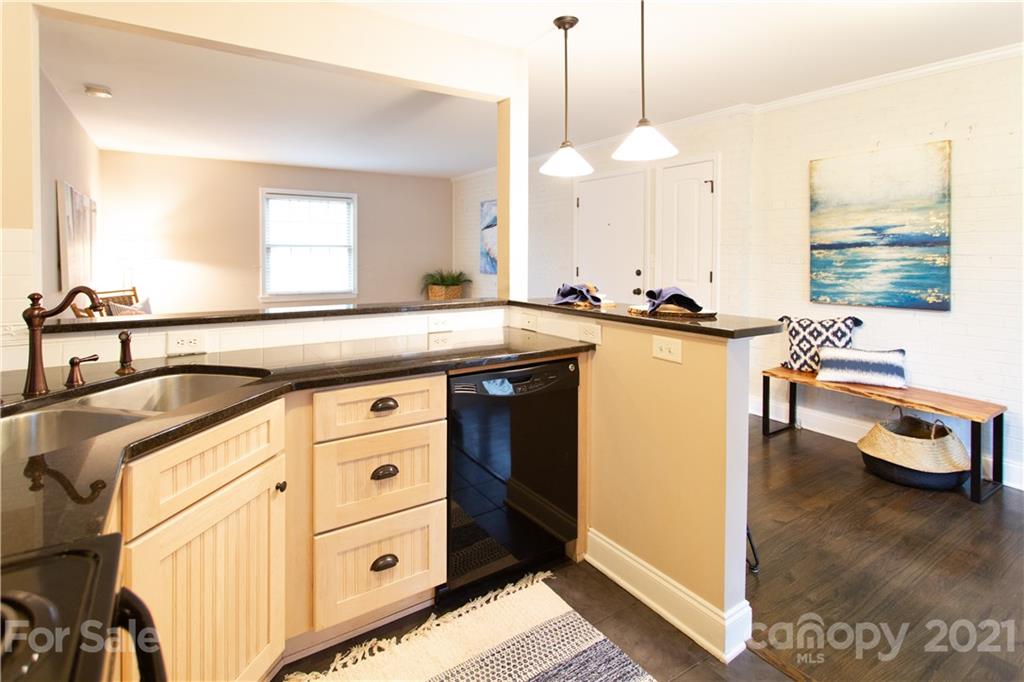4913 Park Road, Unit D Charlotte, NC 28209 - Photo 3 of 32 a kitchen with stainless steel appliances granite countertop a sink a stove and a wooden floors