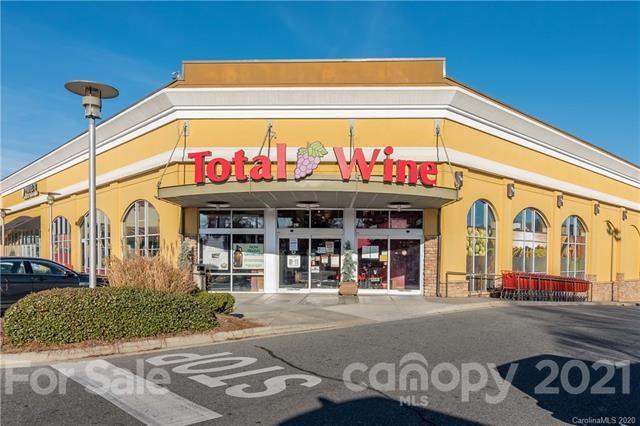 4913 Park Road, Unit D Charlotte, NC 28209 - Photo 32 of 32 a front view of multi story residential apartment building with retail shop and car parked