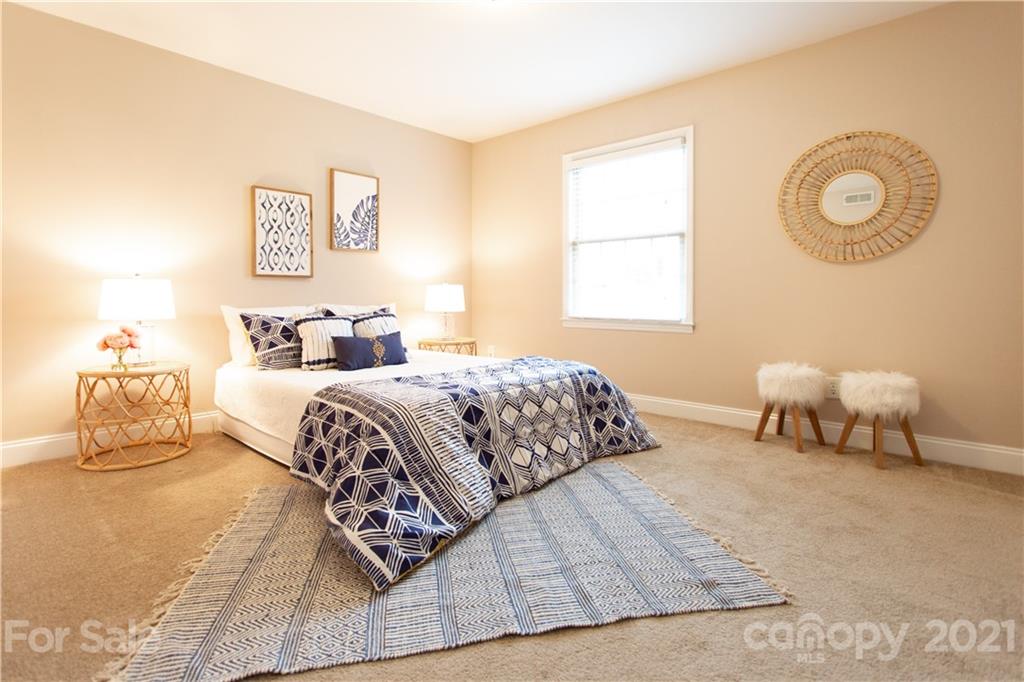 4913 Park Road, Unit D Charlotte, NC 28209 - Photo 8 of 32 a bedroom with a bed and a lamp