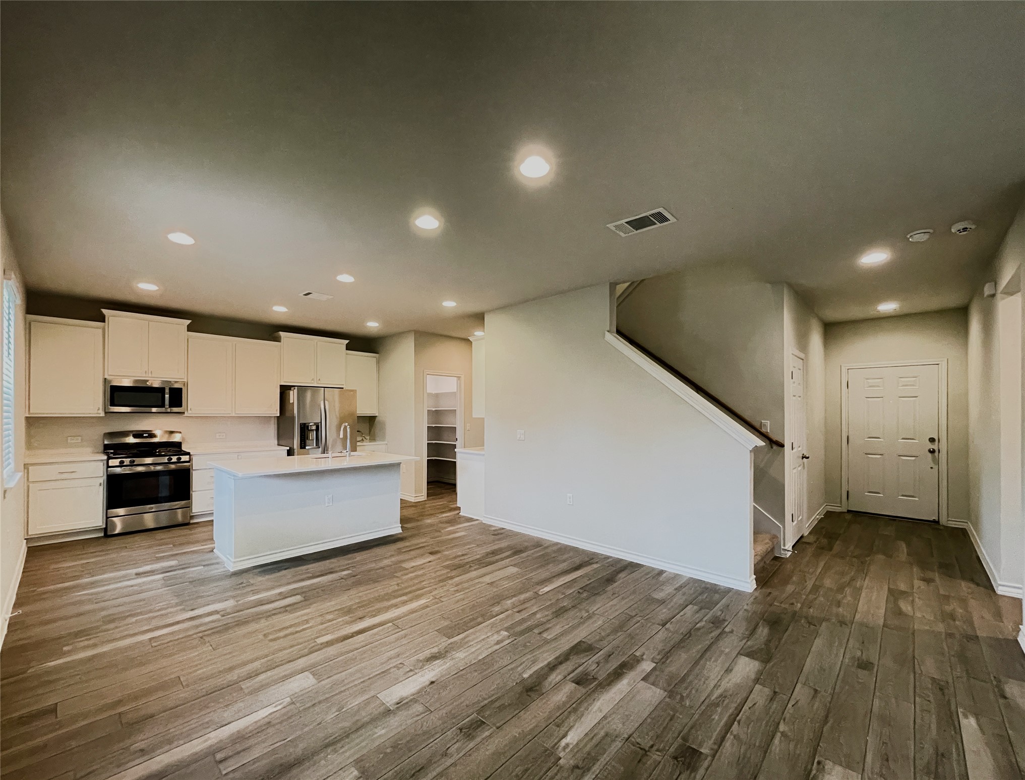 1602 Jacey Way Austin, TX 78725 - Photo 2 of 33 Open-concept living area featuring wood-finish flooring throughout
