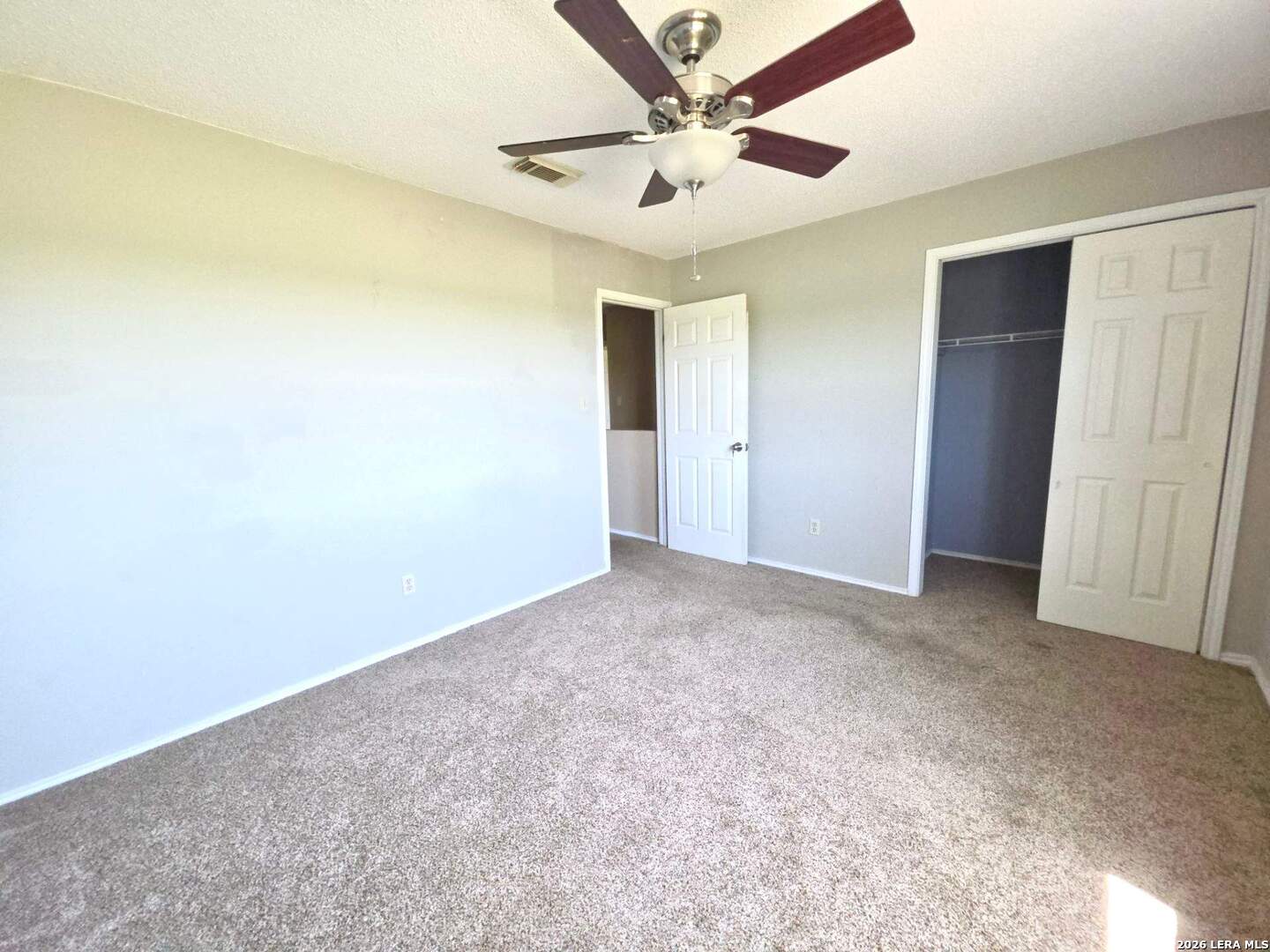 15506 Wheeler Road, Unit 4 Atascosa, TX 78002 - Photo 13 of 23 an empty room with a ceiling fan and carpet