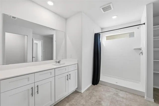 a bathroom with a double vanity sink and mirror