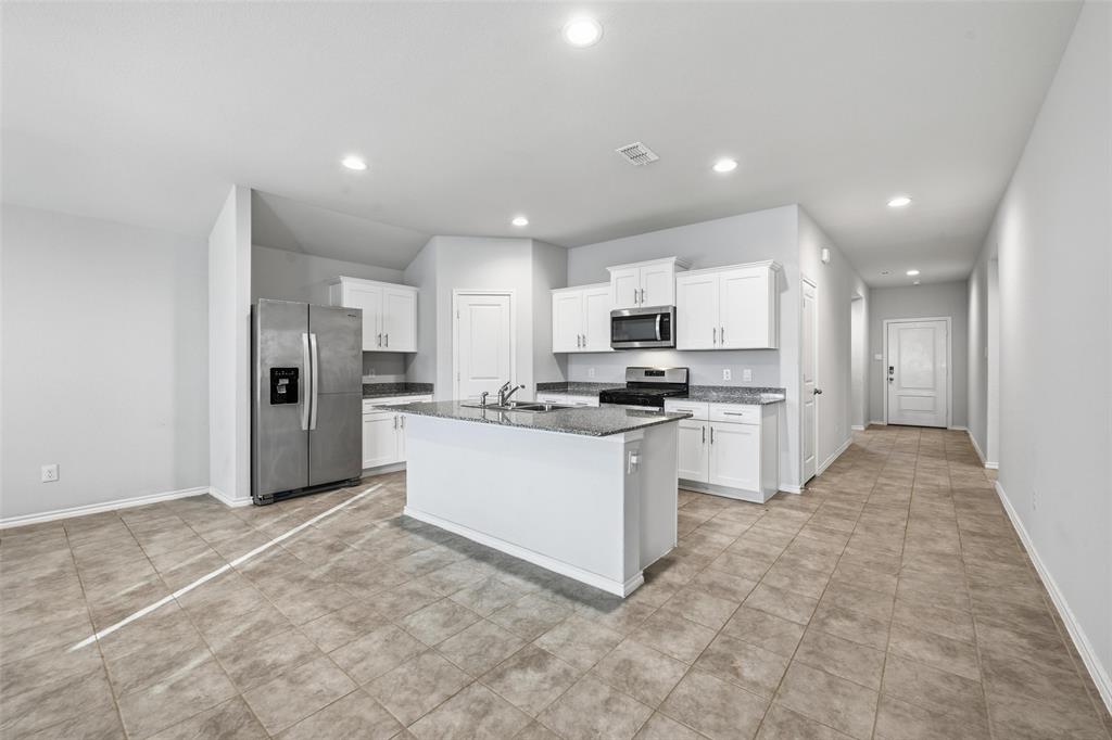 549 Bronze Circle East Springtown, TX 76082 - Photo 4 of 29 a large kitchen with white cabinets and stainless steel appliances