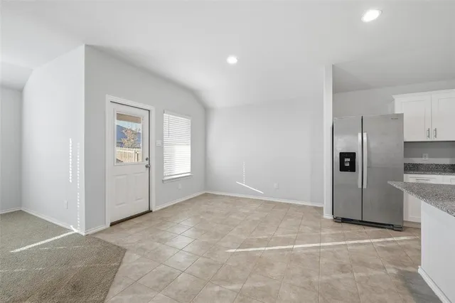 a view of a kitchen with a sink and a refrigerator