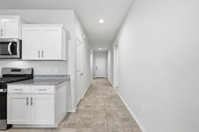 a view of a kitchen with electric appliances