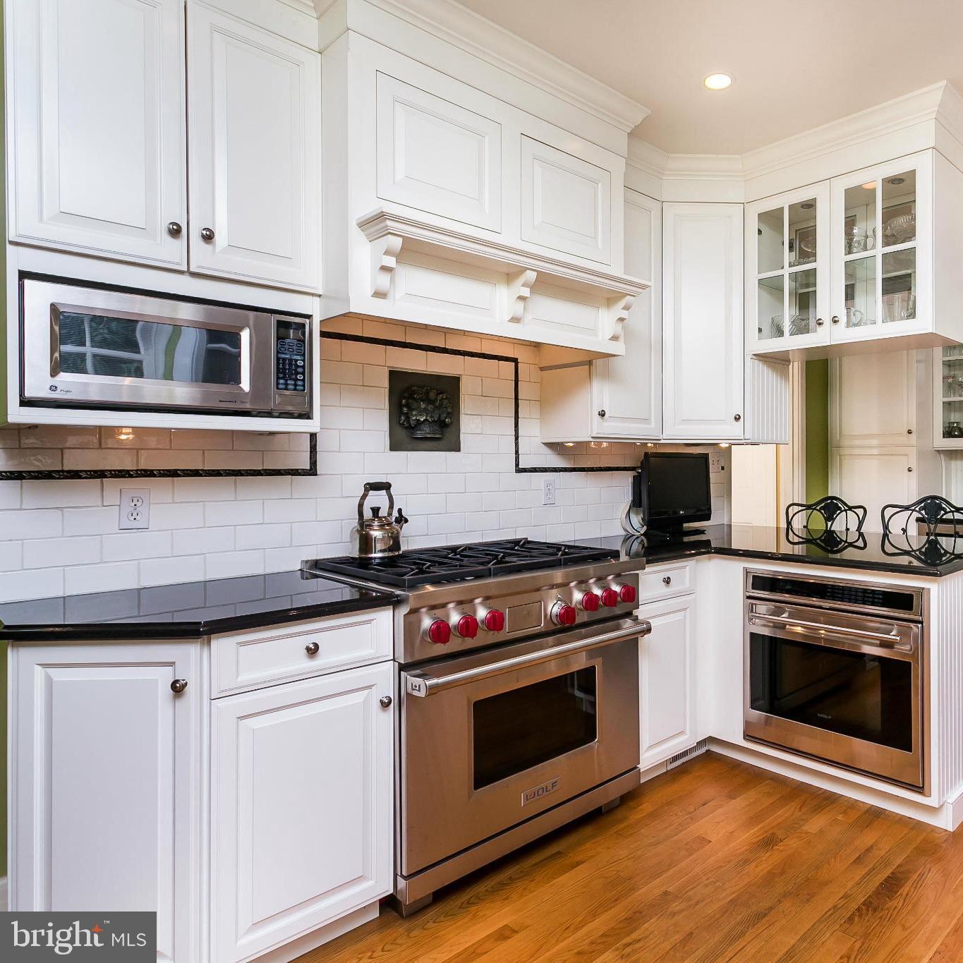 117 Upnor Road Baltimore, MD 21212 - Photo 12 of 32 a kitchen with stainless steel appliances granite countertop a stove and a microwave