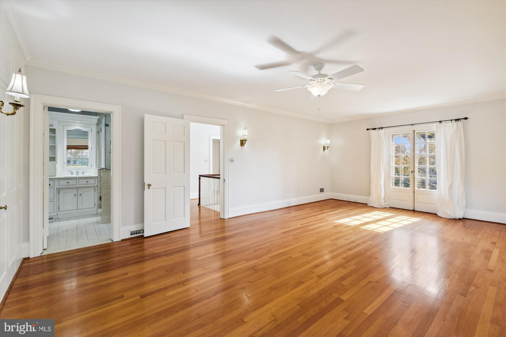 117 Upnor Road Baltimore, MD 21212 - Photo 14 of 32 a view of an empty room with wooden floor and a ceiling fan