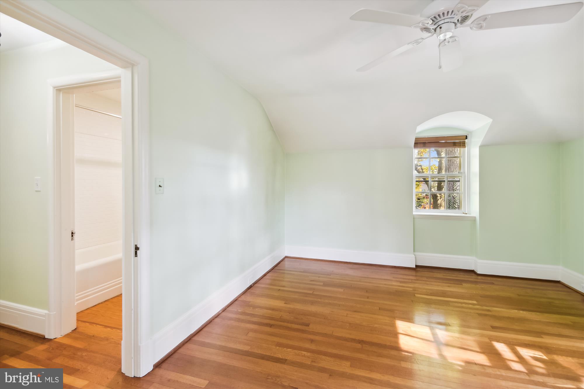 117 Upnor Road Baltimore, MD 21212 - Photo 21 of 32 a view of an empty room with wooden floor and a window