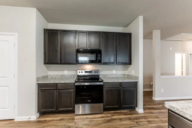 a kitchen with stainless steel appliances granite countertop a stove and a sink