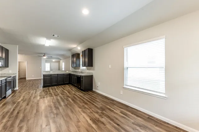 a view of a kitchen with a sink and cabinets
