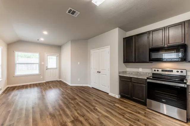 a kitchen with stainless steel appliances granite countertop a stove and a sink
