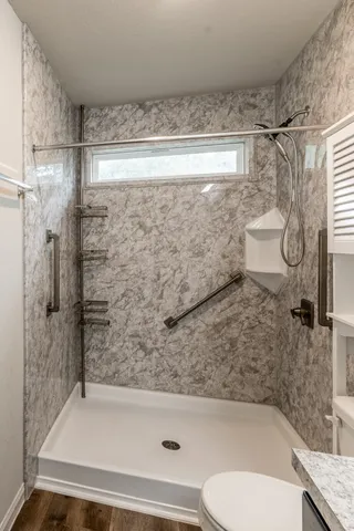 a bathroom with a toilet and a shower