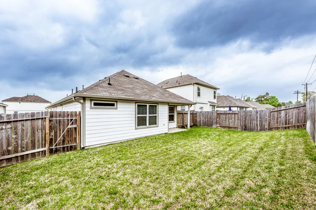 a view of a house with wooden fence