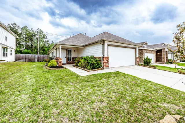 a front view of house with yard and green space