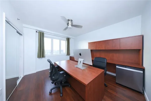 a view of a workspace with furniture and wooden floor