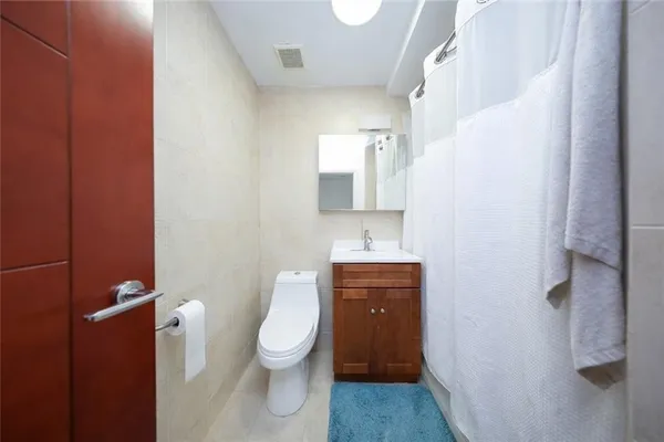 a white toilet sitting next to a bathroom sink