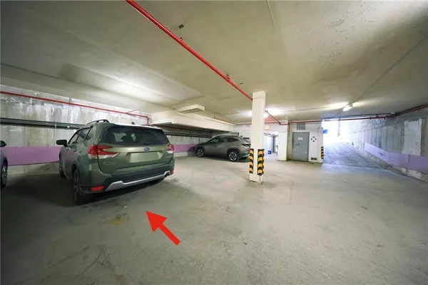 a view of parking garage with cars