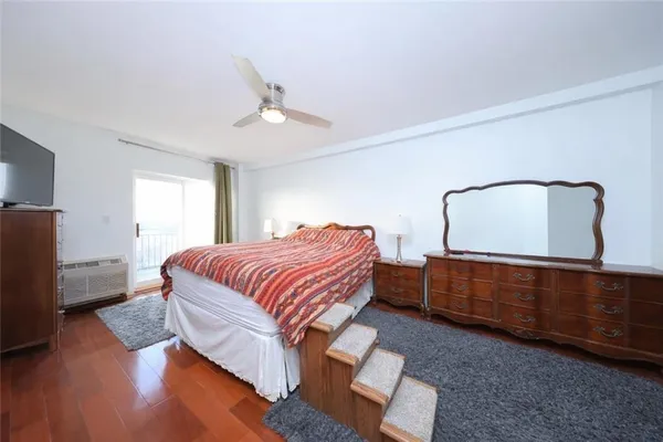 a bedroom with a bed and a dresser