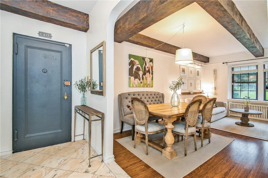192 Garth Road, Unit TP Scarsdale, NY 10583 - Photo 1 of 1 a dining room with wooden floor and large windows