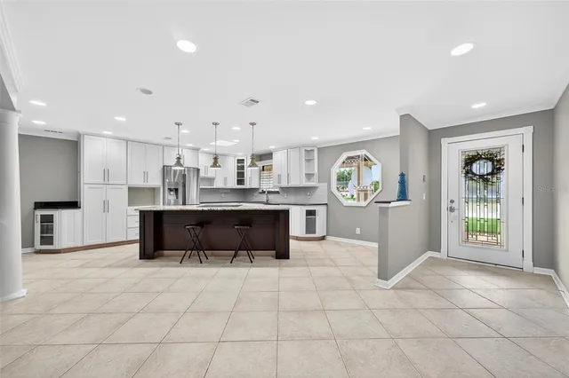 a living room with furniture and large windows