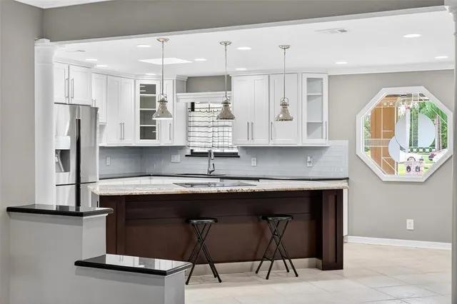 a living room with furniture a fireplace and kitchen view
