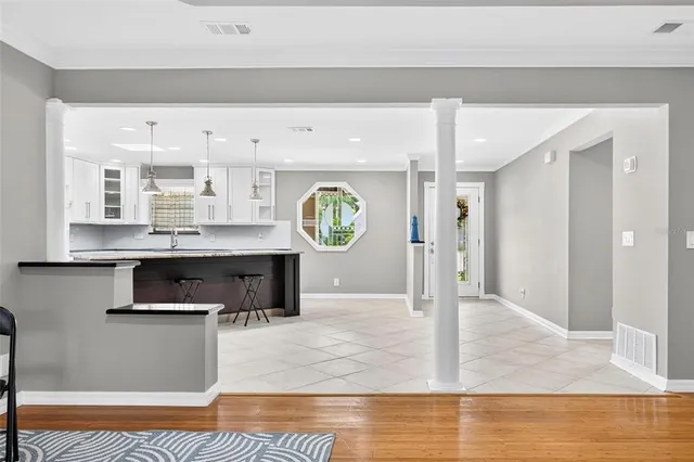 a kitchen with stainless steel appliances granite countertop a sink a stove a refrigerator and island