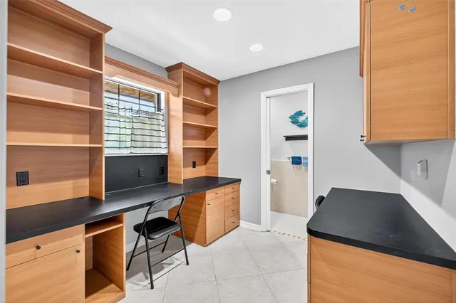 an aerial view of residential houses with outdoor space and trees