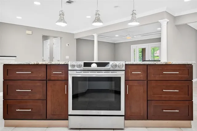 a kitchen with stainless steel appliances granite countertop a refrigerator a sink and a wooden cabinets
