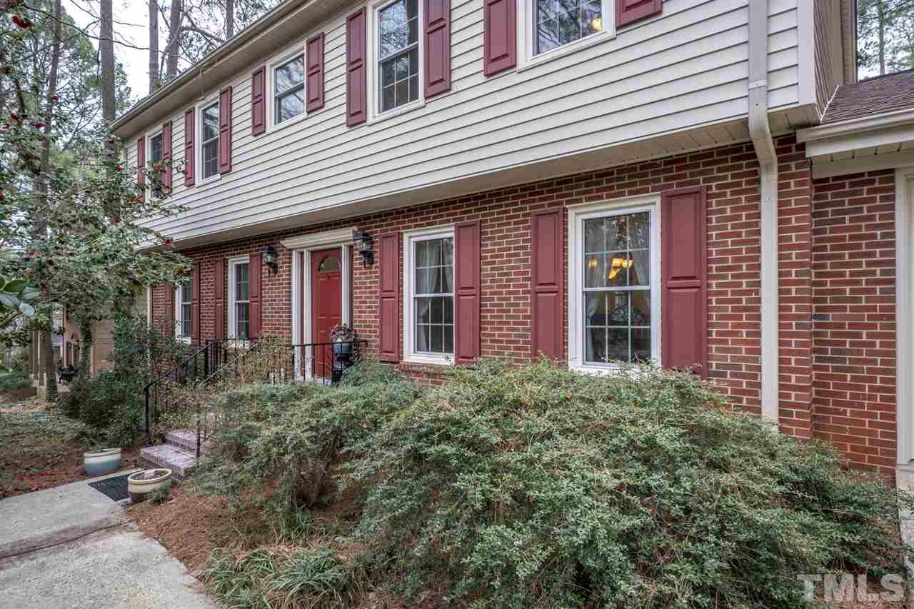 4616 Fernham Place Raleigh, NC 27612 - Photo 1 of 26 a view of a brick house with large windows and plants