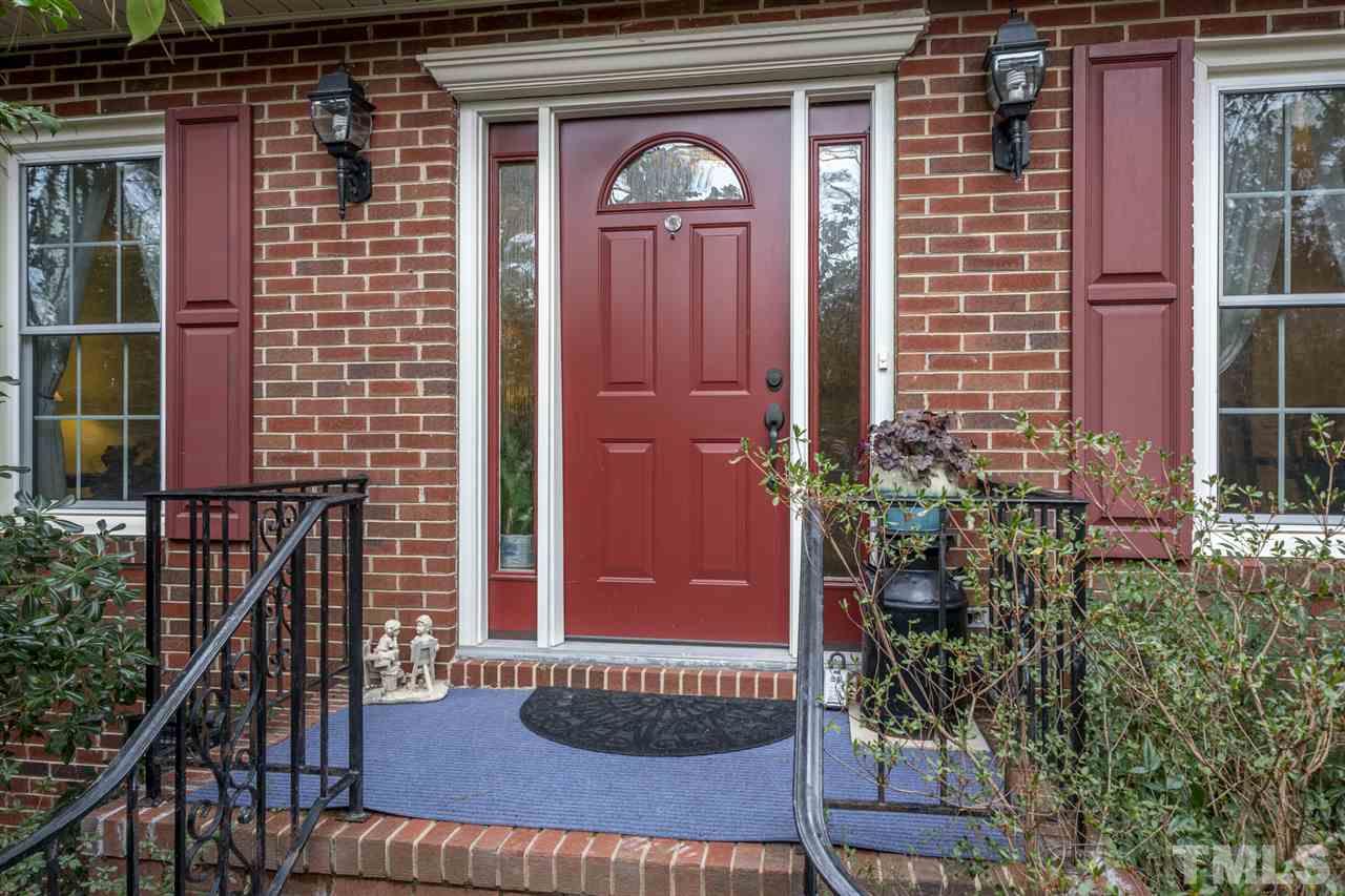 4616 Fernham Place Raleigh, NC 27612 - Photo 2 of 26 a front view of a house with a glass door