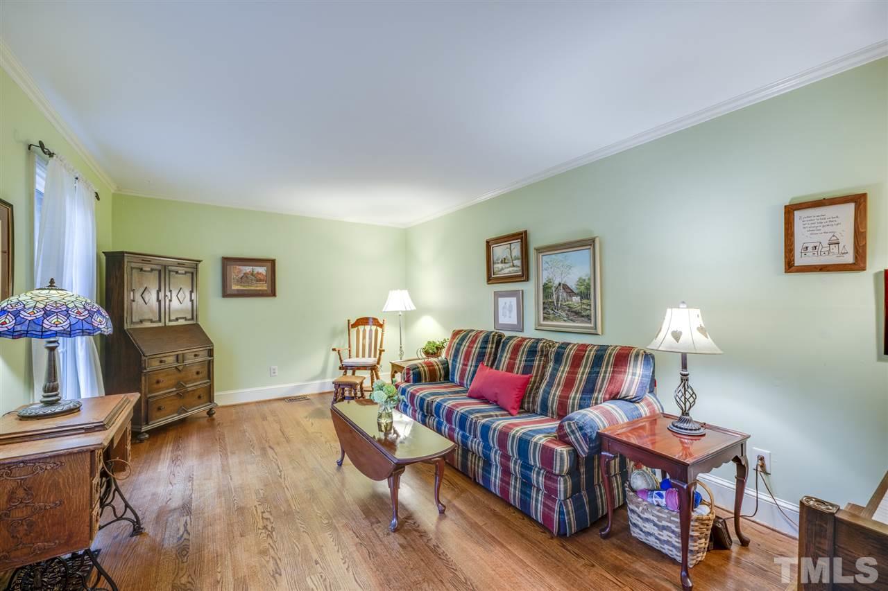4616 Fernham Place Raleigh, NC 27612 - Photo 11 of 26 a living room with furniture and a wooden floor