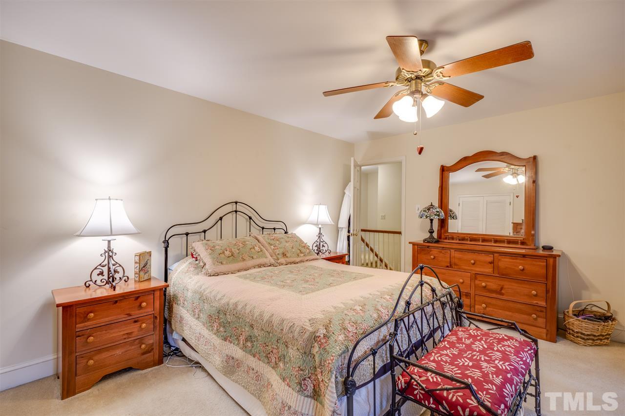 4616 Fernham Place Raleigh, NC 27612 - Photo 12 of 26 a bedroom with a bed and window