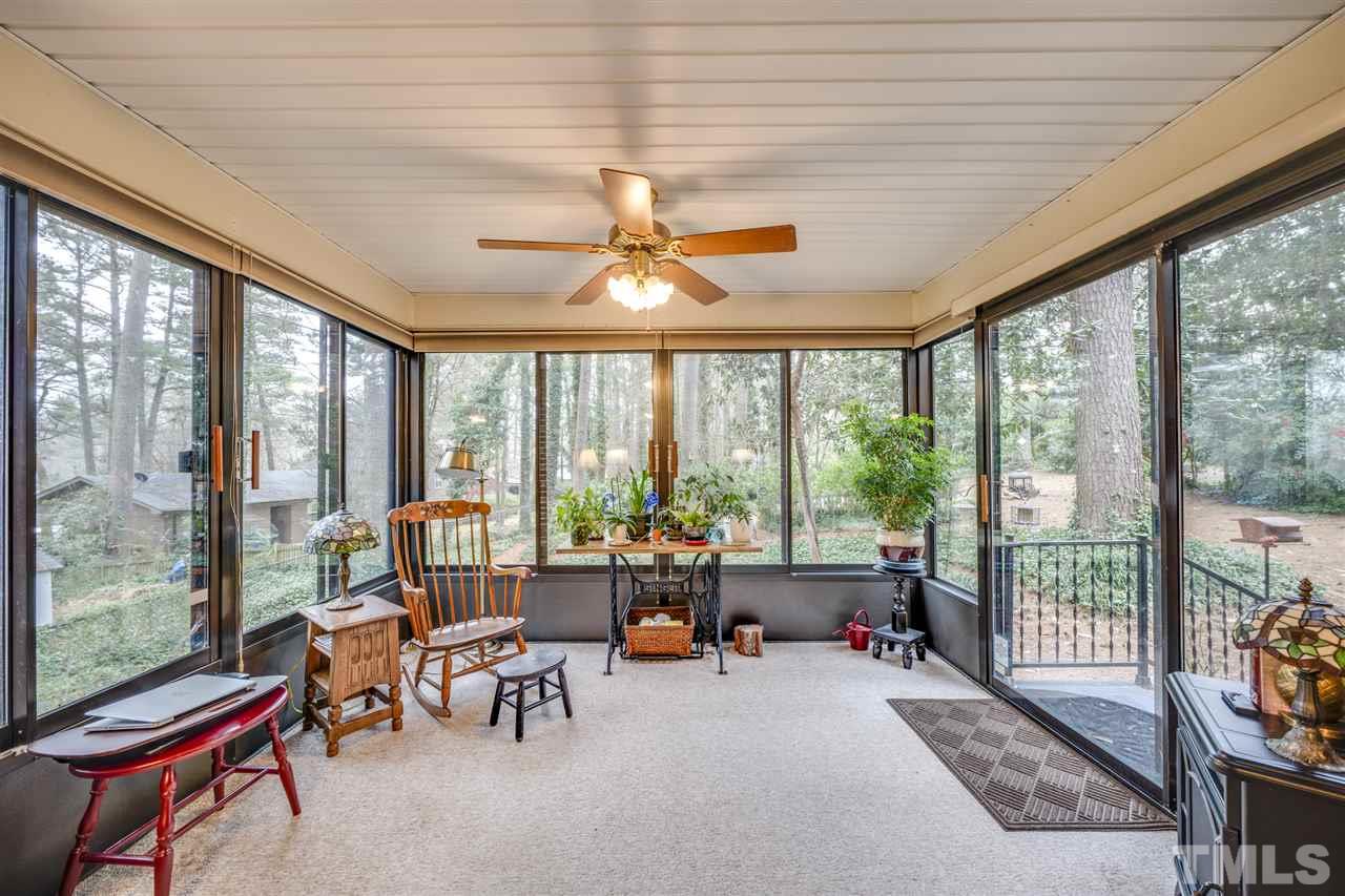 4616 Fernham Place Raleigh, NC 27612 - Photo 17 of 26 a living room with furniture and a floor to ceiling window