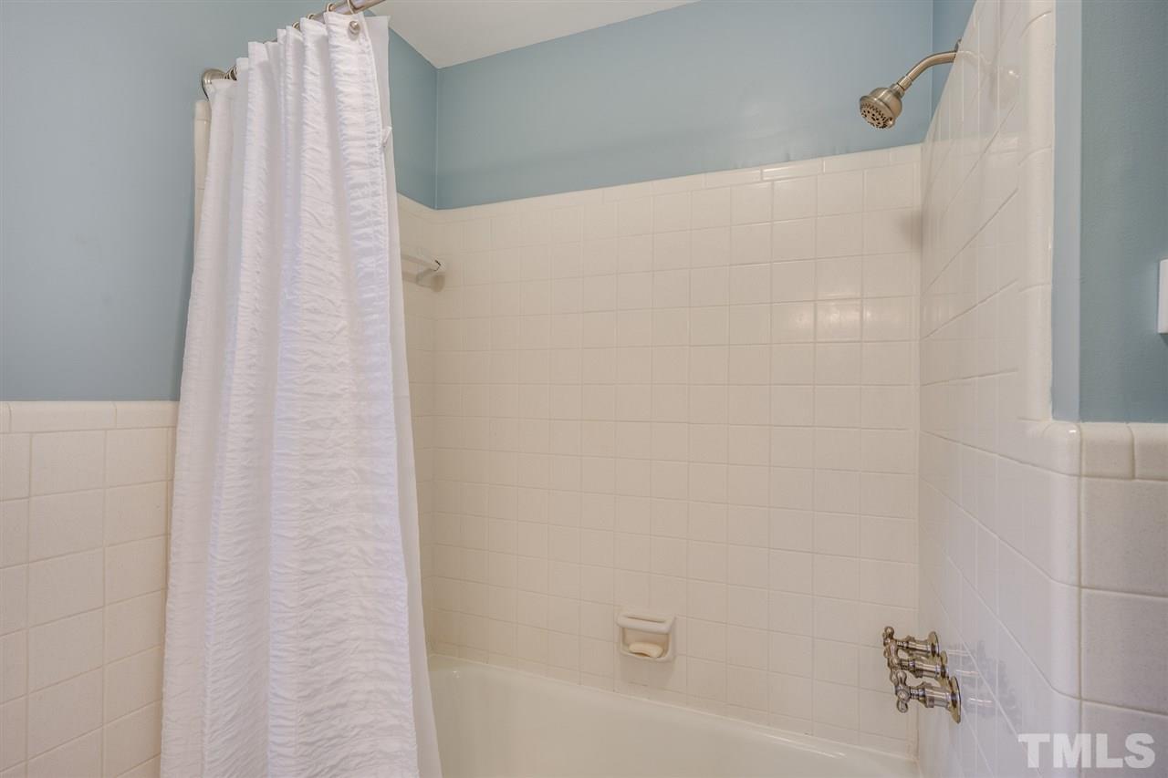 4616 Fernham Place Raleigh, NC 27612 - Photo 20 of 26 a bathroom with a shower curtain
