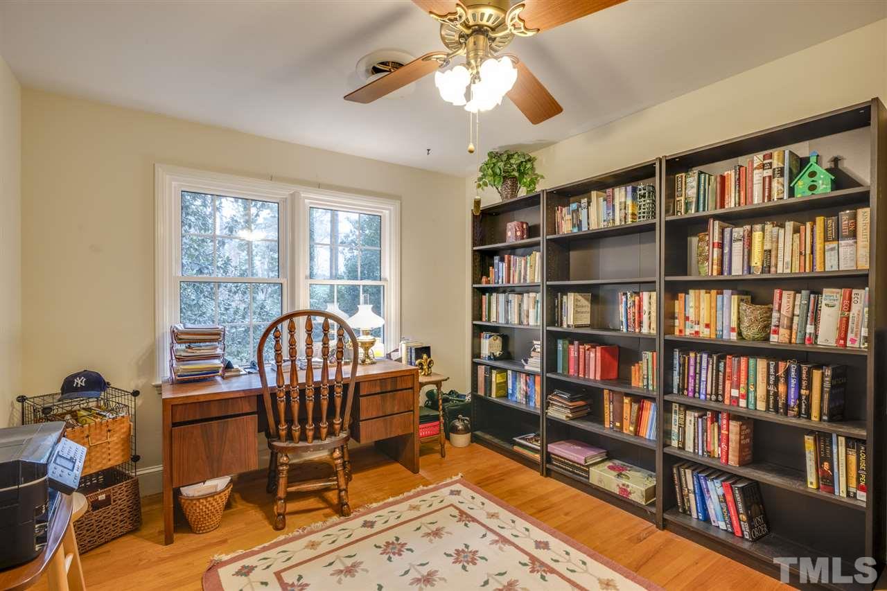 4616 Fernham Place Raleigh, NC 27612 - Photo 22 of 26 a workspace with a bookshelf and a workspace