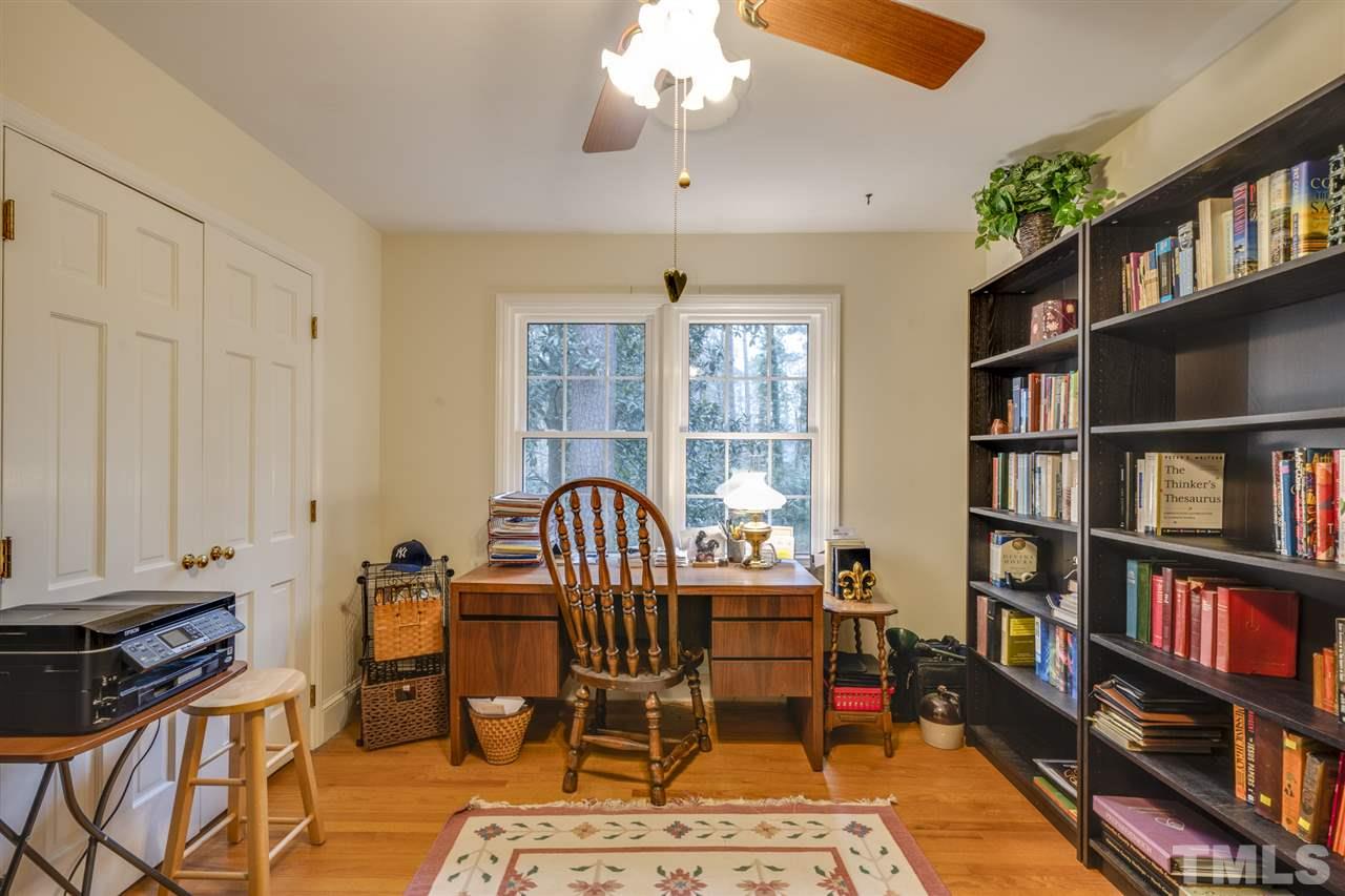 4616 Fernham Place Raleigh, NC 27612 - Photo 23 of 26 a view of a workspace with furniture and a book shelf