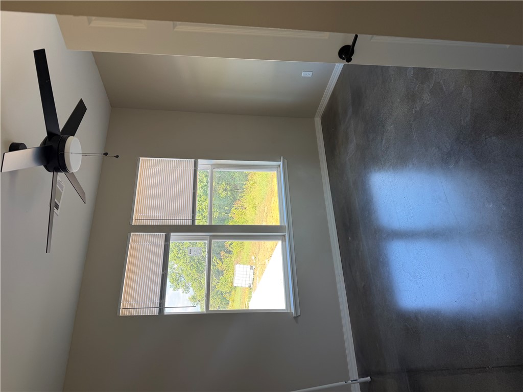 248 Southwest 4th Street Atkins, AR 72823 - Photo 10 of 14 Room featuring polished concrete flooring, neutral wall paint, and a modern ceiling fan with lighting