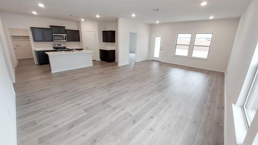 821 Lantana Lane Pilot Point, TX 76258 - Photo 17 of 17 a view of kitchen with kitchen island microwave and stove