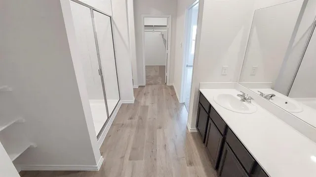 a bathroom with sink a mirror and a bathtub