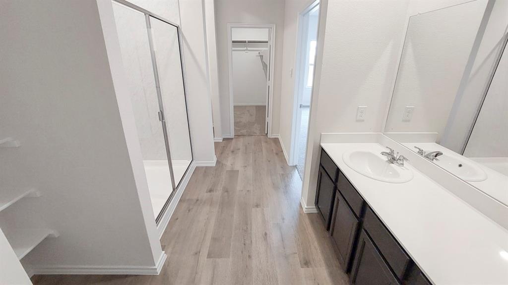 821 Lantana Lane Pilot Point, TX 76258 - Photo 14 of 17 a bathroom with sink a mirror and a bathtub