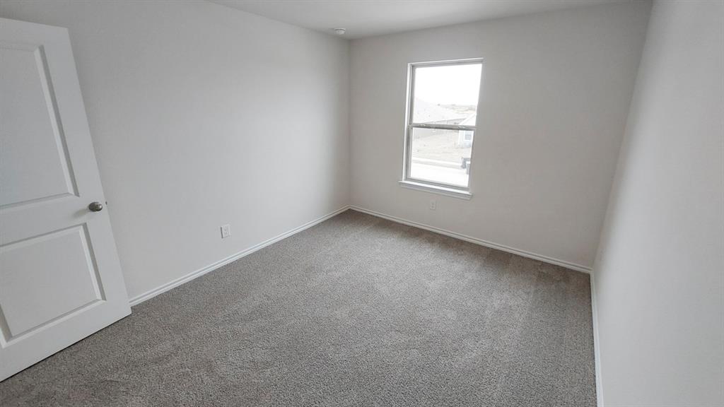 821 Lantana Lane Pilot Point, TX 76258 - Photo 8 of 17 an empty room with a window